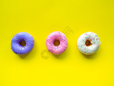 甜甜圈有颜色的橙色白紫粉 高能量食品和健康价格 甜甜糖 背景图画等橙子紫色口味费率粉色白色甜味图片