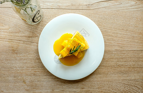芒果芝士蛋糕桌子风格铸铁美食盘子小枝装饰迷迭香甜点奶油图片