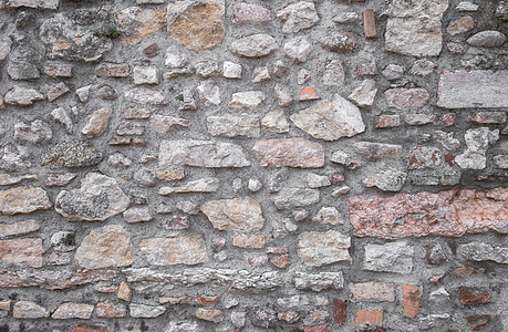古老的天然石墙水泥白色墙纸风化建筑学棕色褐色地面黑色石头图片