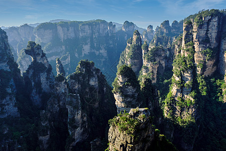 中国张家江山岩石地标砂岩公园山脉柱子游客化身日落悬崖图片