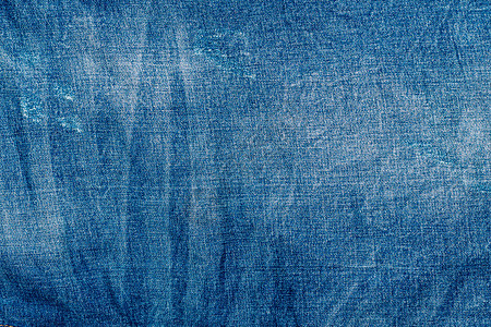 淡蓝色的破旧牛仔裤 牛仔面料 在生产中老化纺织品蓝色帆布青年装饰墙纸衣服风格棉布空白背景图片