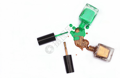 绿色和金甲 白上喷洒抛光凝胶金子搪瓷美甲液体金属美丽化妆品瓶子背景图片