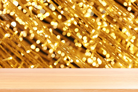 散景金黄色彩色背景上的木板 散景上的空木桌地板闪闪发光的浅金色奢华 木桌板空前闪闪发光的金色 散景照明上的木制闪闪发光的金色微光背景图片