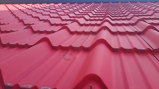 屋顶瓦片的背景纹理橙子天空平铺材料房子红色住宅陶瓷蓝色建筑学图片