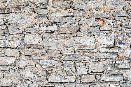 由天然石材制成的粗糙墙壁水泥历史石墙石头长方形积木风化墙纸黏土岩石背景图片