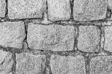 旧石砖墙的单色背景建造建筑学材料卵石花岗岩灰色黑色白色建筑圆形图片