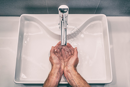 在工作浴室水槽用肥皂洗手 以防止冠状病毒爆发 经常洗手20秒预防冠状病毒大流行图片