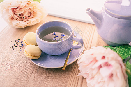 茶杯回家 供应一个英式黑茶黑茶 茶壶和面条饼干以及可爱的粉红花朵装饰品图片