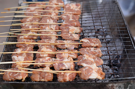 新鲜猪肉在木炭烧烤炉上切开的鲜猪肉背景图片