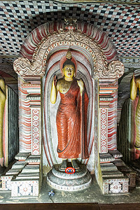 站在Dambulla洞穴的佛像地标雕像寺庙岩石神社历史世界遗产建筑学文化雕塑图片