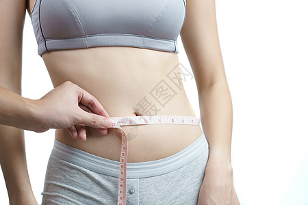 女人用胶带量度腰部卷尺身体燃烧女孩饮食女士测量重量磁带腰围图片