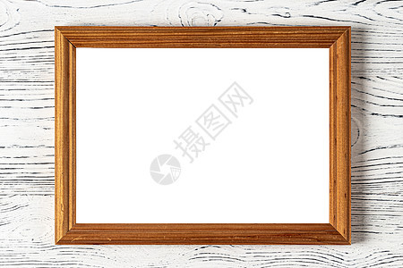在混凝土或装饰性石膏墙上的木质地板和照片框上 有复制文本背景空间白色笔记本帆布羊皮纸文书框架空白桌子木头褪色图片