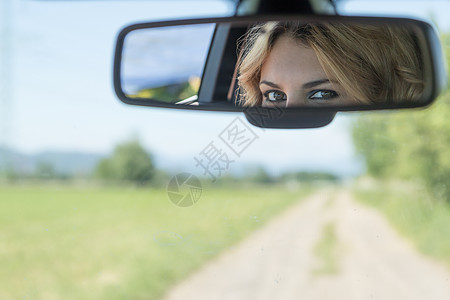 年轻女司机的双眼在后视中被反映图片