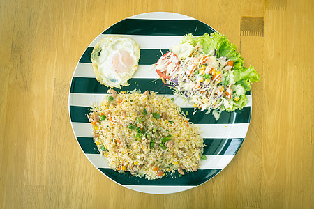乌尔猪肉炒米饭 沙拉和炸鸡蛋在文特的顶端景色图片