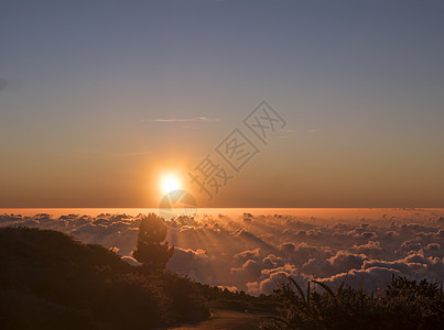 西班牙加那利岛La Palma山的白云覆盖面上美丽的红日落 有阳光和沥青路作品太阳火山岩石情绪天空蓝色射线地平线橙子图片