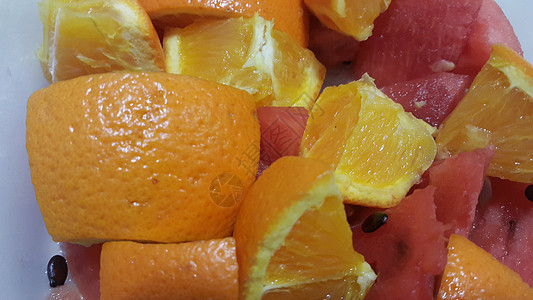 近距离观察混合水果柑橘橙子和甜红西瓜的果实切片种子食物热带甜点小路饮食剪裁小吃橙子西瓜片图片
