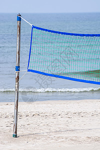 海滩排球场在海滩上团队娱乐游戏晴天比赛自由小麦海洋天空假期图片