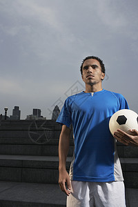 男子在户外拥有足球球男人位置种族外观地带一人对象运动装蓝色混血图片