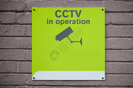 特写墙上的CCTV在运行中标志隐私警告监控设备问题监视监视器社会政治摄像头图片