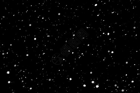 黑背景上的雪白色雪花风暴黑色天空背景图片
