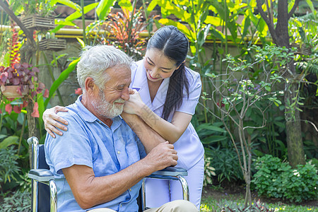 护士照顾一名年长的男性 在他花园里坐在轮椅上医生公园女性快乐老年讲话女士残障照顾者成人图片