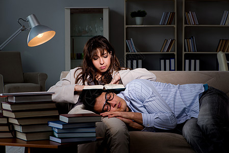 两名学生在考试准备迟到时学习睡眠学校大学教科书时间女士青少年阅读家庭作业过夜图片