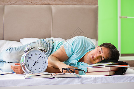 学生们准备在家参加卧房里躺在床上的考试压力教育男人图书实习生假期学校教科书训练学习图片