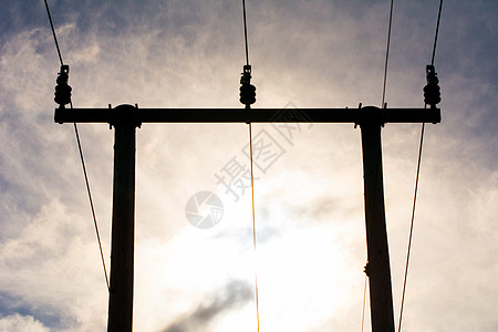 日落时 木质电线杆与电线合在云层的天空中图片