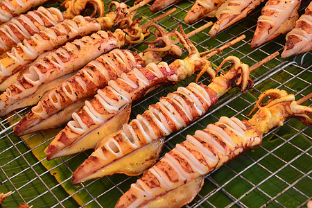 泰国街头食物的灰丝袜异国店铺木炭街道饮食动物叶子章鱼烧烤小吃图片