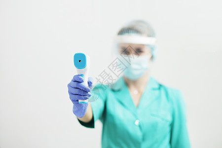 医院戴防护面具的女医生或护士手握有气压计预防感染流感女士药品专家安全口罩女性社工图片
