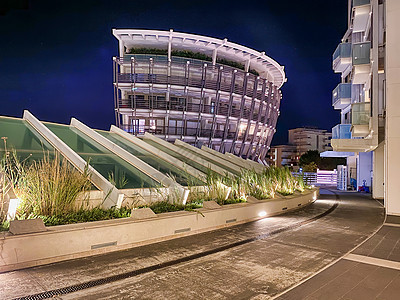 里米尼 伊塔利     8月26日 2020年 城市港口和Bui的夜视未来派蓝色街道都市办公楼建造业窗户旅游反射省会图片