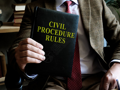 民事诉讼程序规则 商务人士手里拿着一本书呢!图片