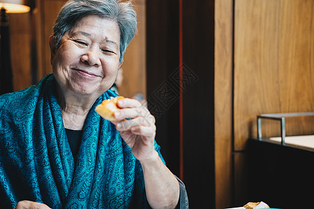 年长的亚洲老年老年妇女在餐厅吃面包祖母美食女性午餐老人女士退休成人食物图片