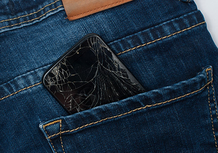 口袋里的电话织物屏幕蓝色牛仔裤棉布玻璃衣服细胞纺织品裂缝图片