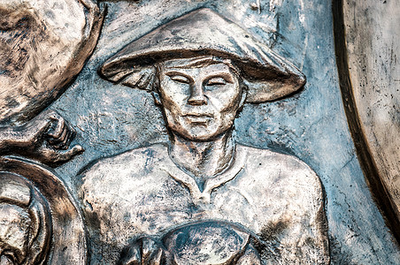 和戴帽子的人一起在越南 亚洲的纪念碑的一部分建筑历史男人艺术青铜文化浮雕旅行旅游男性图片