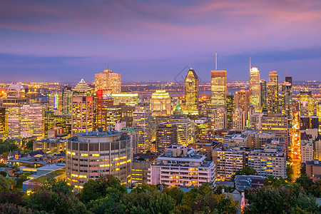 从加拿大日落时的顶端观点看蒙特利尔建筑物旅游全景树叶建筑景观办公室蓝色城市日出图片