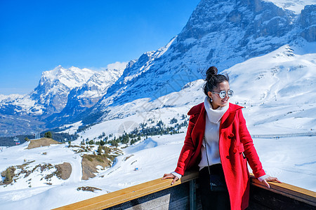 年轻女旅游者在附近看到美丽的观景台火车滑雪高地顶峰运输蓝色高山假期铁路车站图片