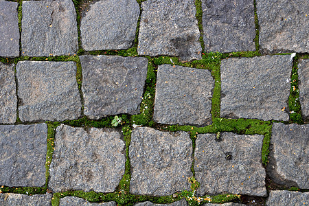 人行道的石头背景 一个古老的cobblestone街道近距离特写的简要背景城市鹅卵石历史性铺路建筑学小路大街行人正方形路面图片