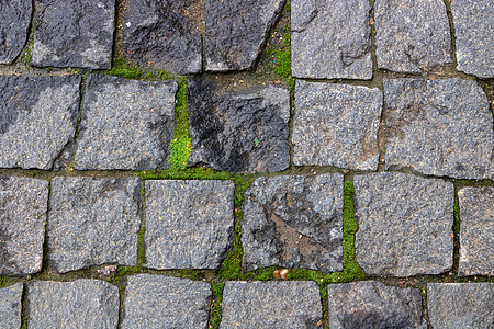 人行道的石头背景 一个古老的cobblestone街道近距离特写的简要背景花岗岩建筑学行人小路鹅卵石城市正方形路面大街建造图片