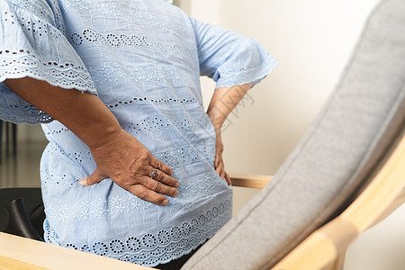 老年妇女在家背背痛 保健问题概念男人女性腰痛缰绳卫生伤害紧张痛苦客厅祖母图片
