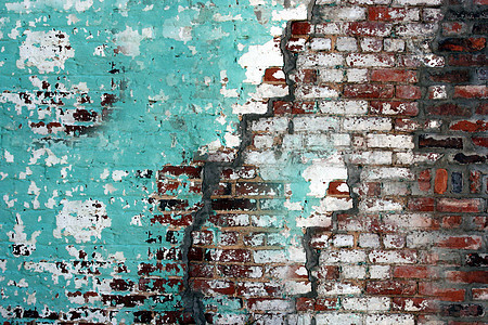 旧房子破碎的墙壁被涂上绿色和白漆图片