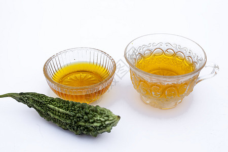 白色分离的流行排毒凉茶 即与蜂蜜及其成分分离的苦瓜或苦黄瓜茶葫芦桌子黄瓜玻璃薄荷重量柠檬绅士杯子损失图片