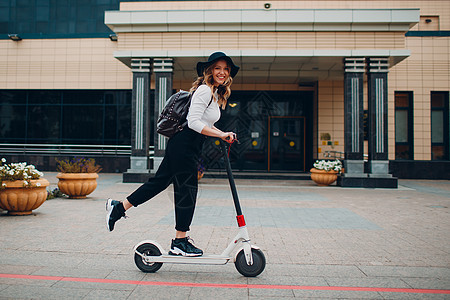 城市有电动摩托车的年轻女子生态成人车辆女孩女性车轮自行车运输商务速度图片