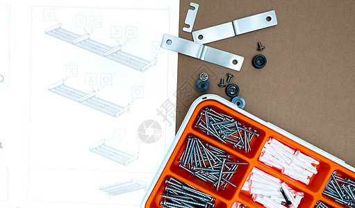 橙色塑料盒中的螺旋和墙插件金属成套硬件安装盒子架子操作机械插头作坊图片