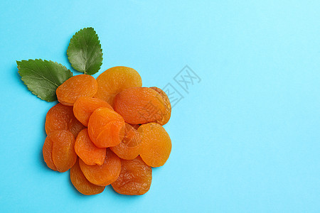 盐酸干杏仁和蓝底叶叶饮食橙子食物工作室营养团体杏子框架蓝色水果图片