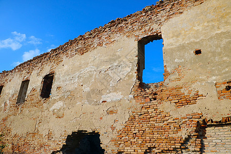 一座旧红砖楼的废墙堡垒建筑风化框架石头损害水泥建筑学石工裂缝图片
