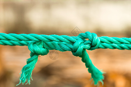 绳结结特写 中间有两个打结的绳子 与背景隔离开来 信任强度安全支持信念和团结概念的象征 说明性概念照片纤维镜框十字形航海压力力量背景图片