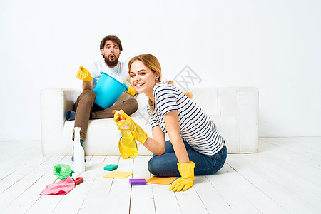 女人洗地板 一个男人坐在沙发上 在家里做内脏清洁快乐手套女士家庭主妇服务清洁工家庭卫生成人女性图片