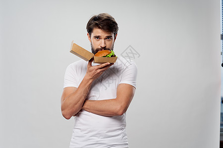 带一箱汉堡包的男子 快速食物卡路里肖像图片