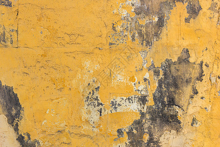 具有模具背景的黄色墙壁裂缝风化石膏古董材料墙纸建筑水泥房子建筑学图片